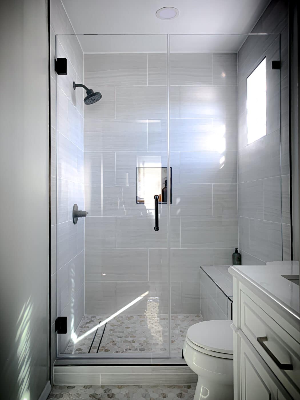 Hinged frameless shower door + fixed panel &mdash; matte black &mdash; san clemente