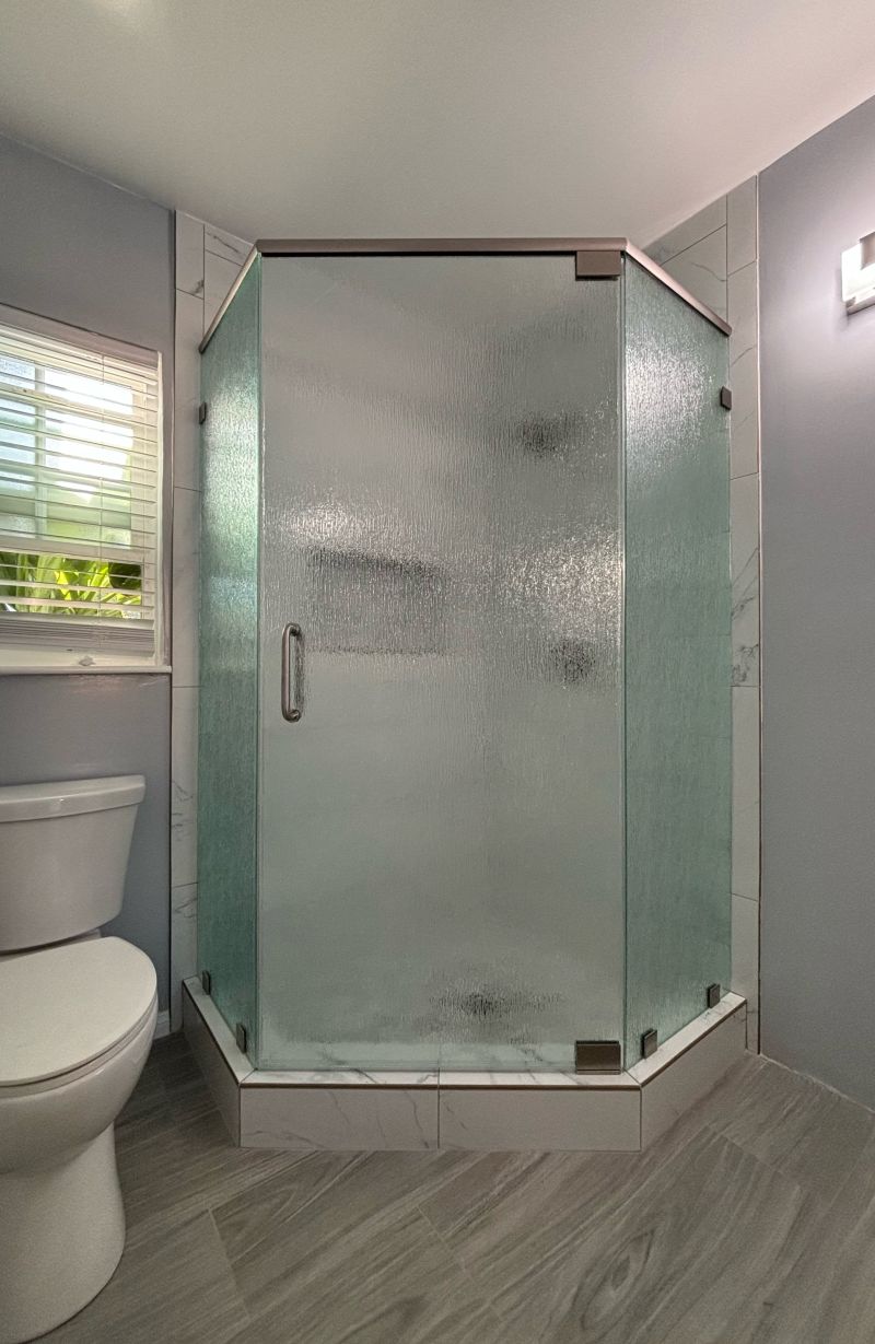 Rain-glass neo-angle shower enclosure with a header and pivot hinges in Anaheim