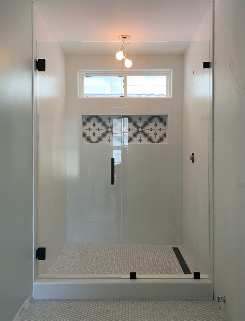 In-and-out swinging shower door and fixed inline panel in Carlsbad