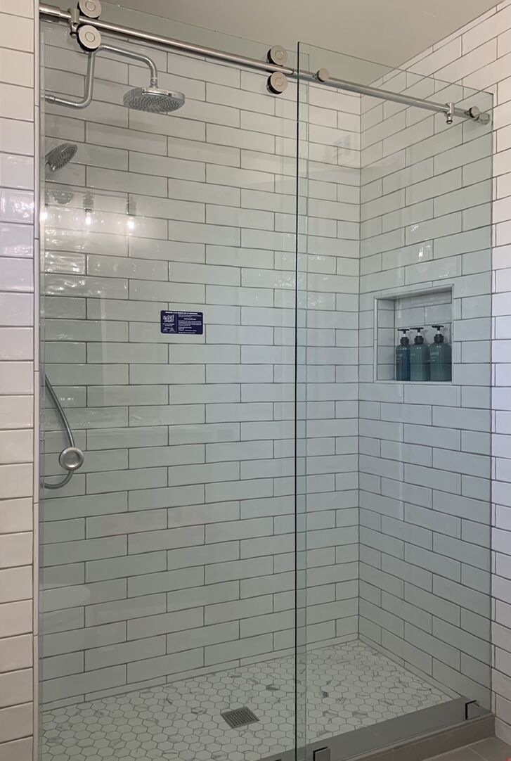 Euroglide sliding shower enclosure against white tile in Carlsbad
