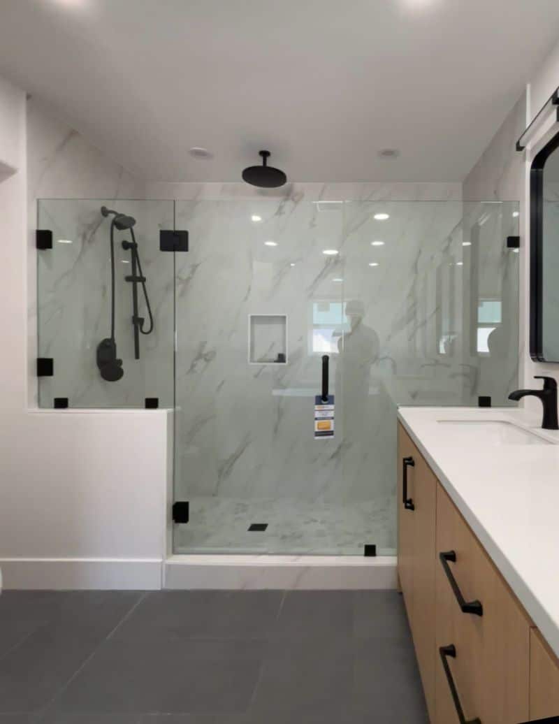 Carlsbad panel-door-panel shower with half-inch stationary glass and CWM clamps