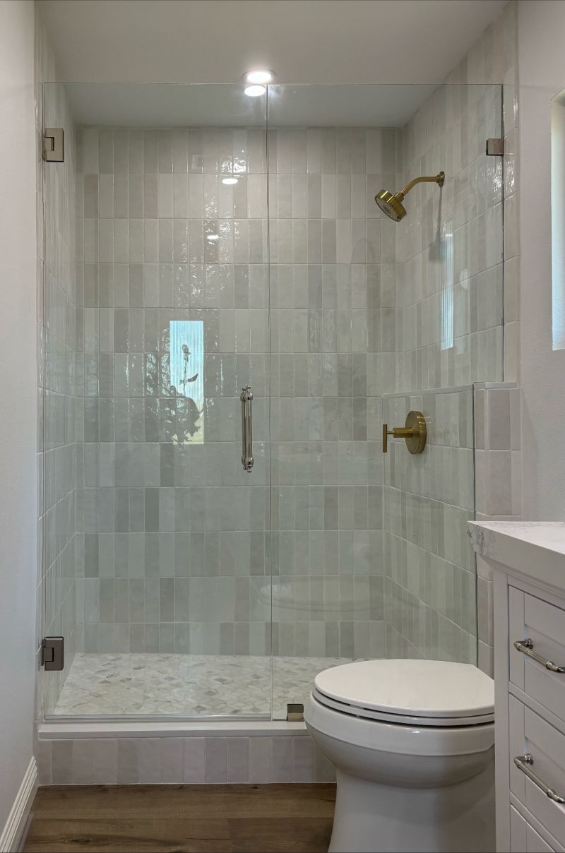 Door-and-inline shower glass with polished nickel hardware in Encinitas