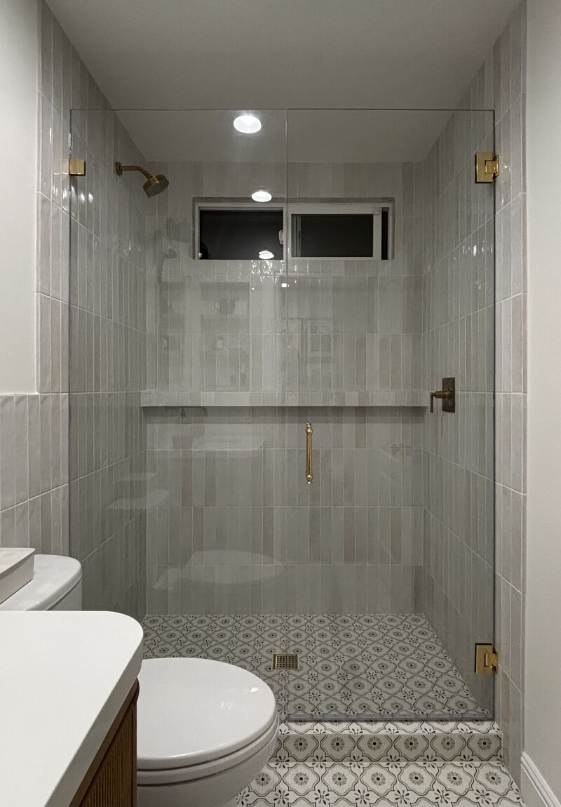 Encinitas shower door and inline glass with CRL unlacquered-brass hardware