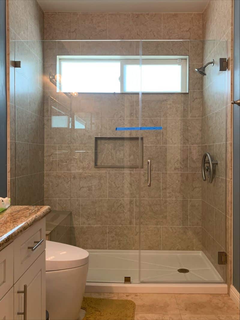 Escondido door-and-inline shower glass fitted with a bench notch