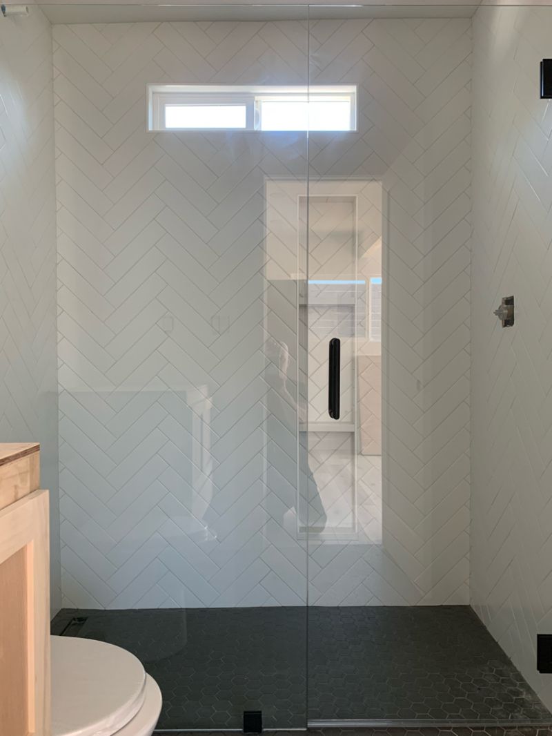 Clear hinged shower door and inline panel in Escondido