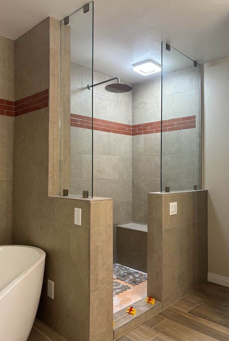 Completed open-entry shower with two fixed splash panels in Escondido