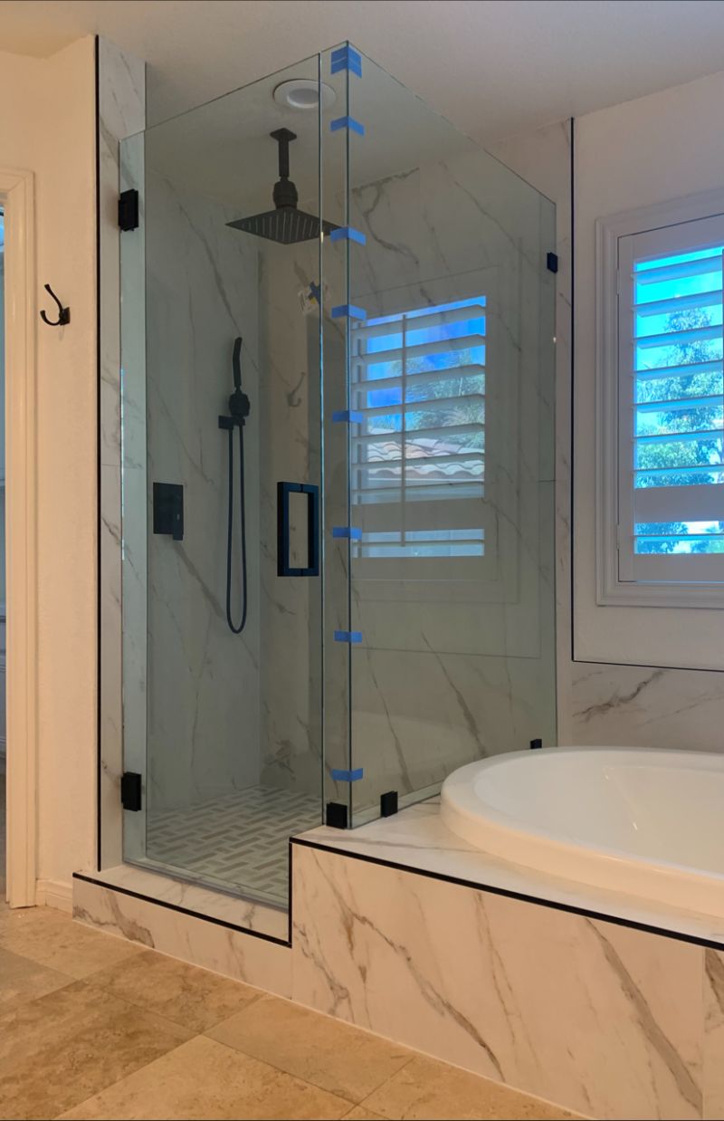 In-and-out swinging corner shower with a return on a tub deck in Escondido