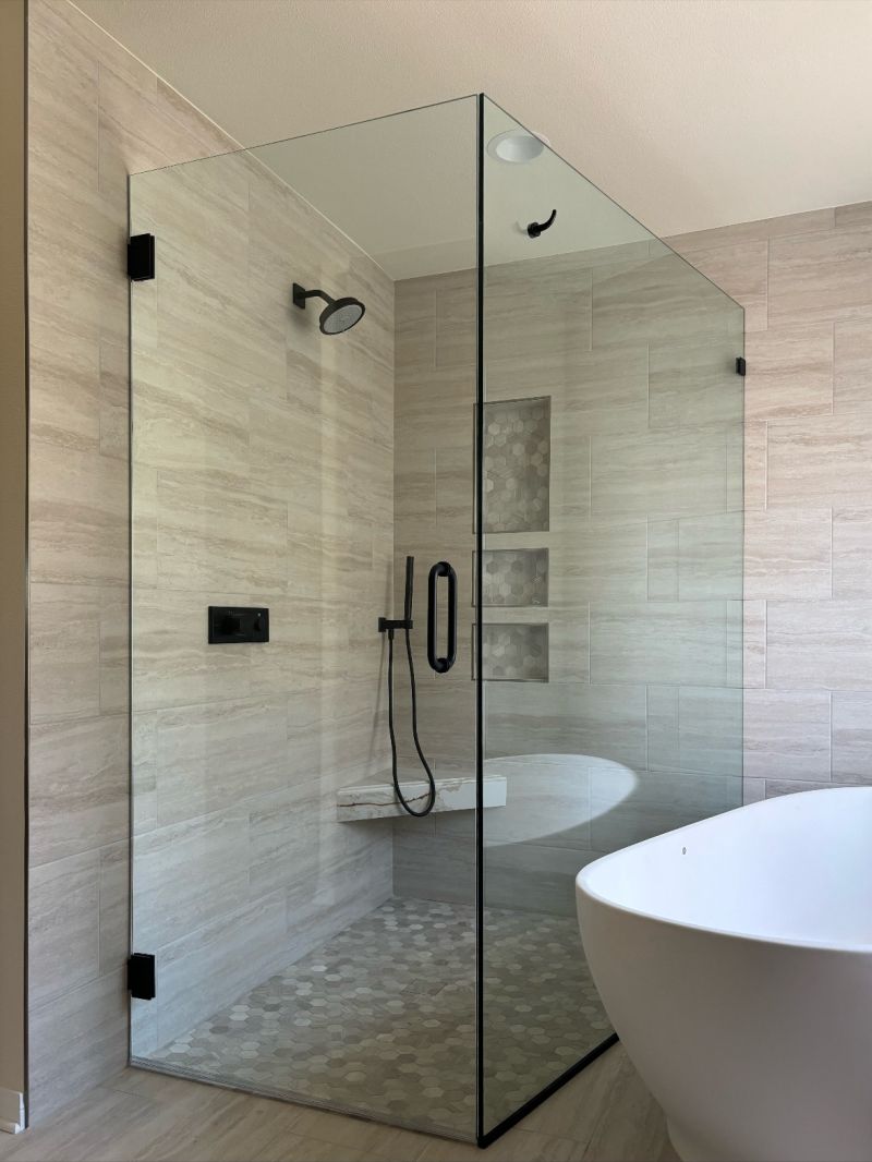 Curbless frameless corner shower enclosure with a 34-inch door installed in Huntington Beach