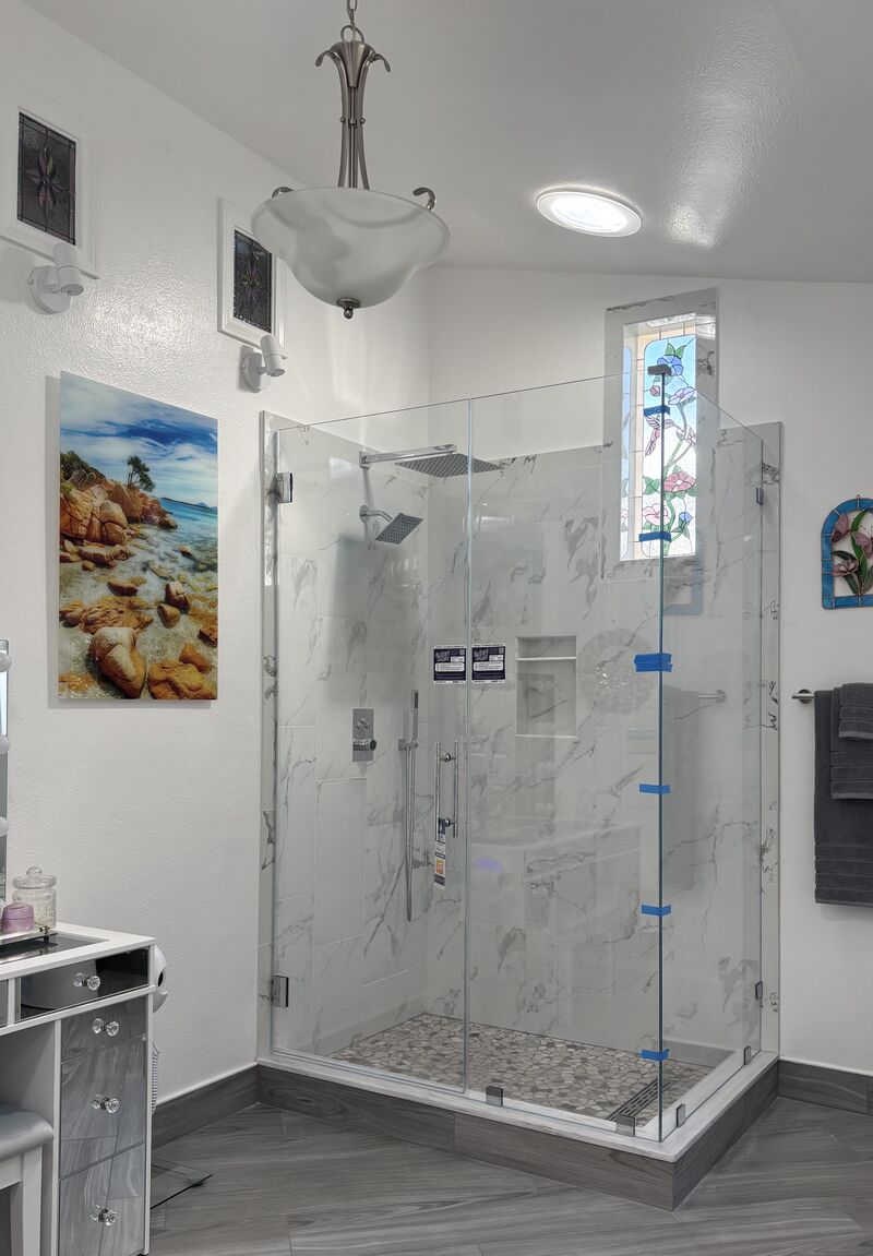 Eighty-four-inch Opti-White low-iron frameless corner shower enclosure installed in Huntington Beach