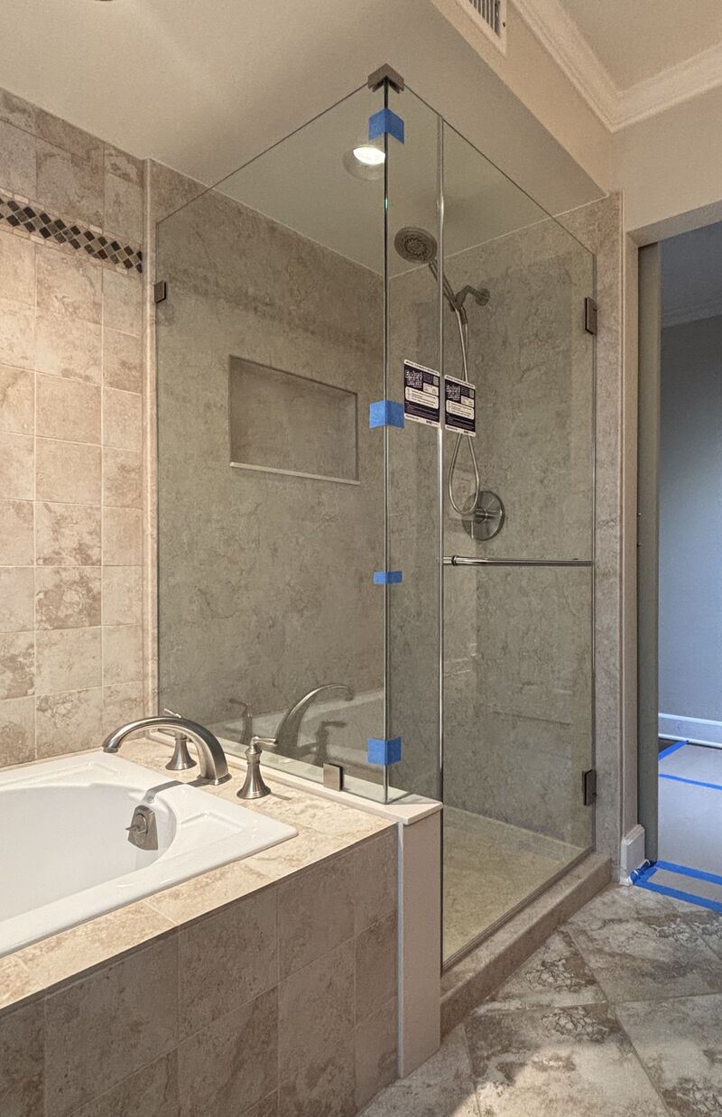 Frameless corner shower enclosure on a tub deck with EnduroShield in Huntington Harbour