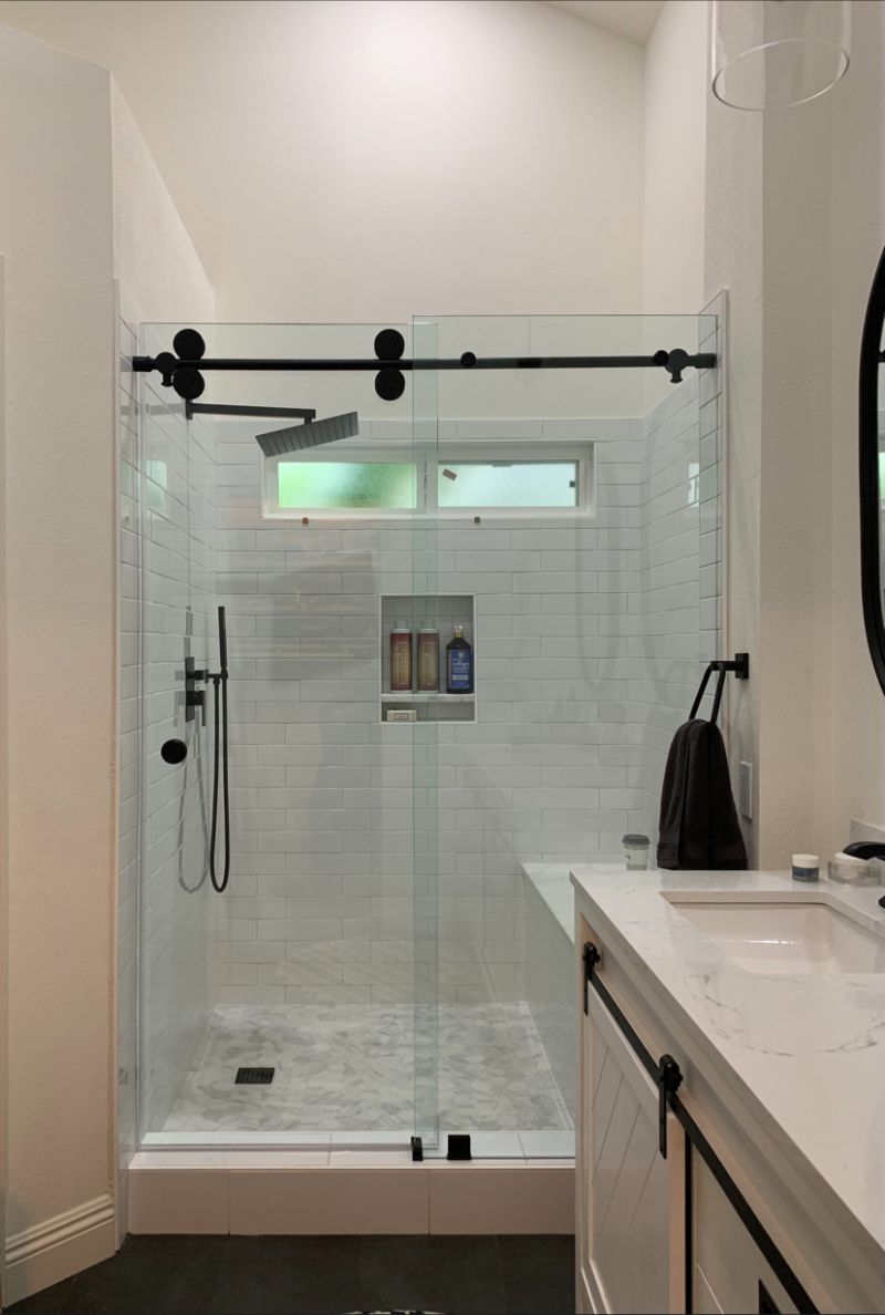 Matte-black Euroglide sliding shower enclosure installed in Laguna Niguel