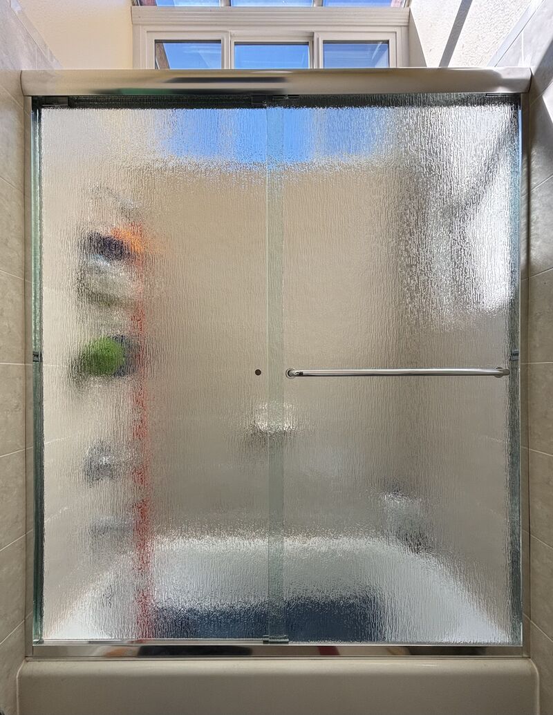 Patterned rain-glass bypass sliding shower enclosure installed in Laguna Niguel