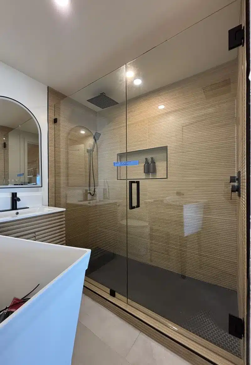 Oversized half-inch frameless door and inline panel in San Clemente, with a 147-pound fixed panel and 101-pound door