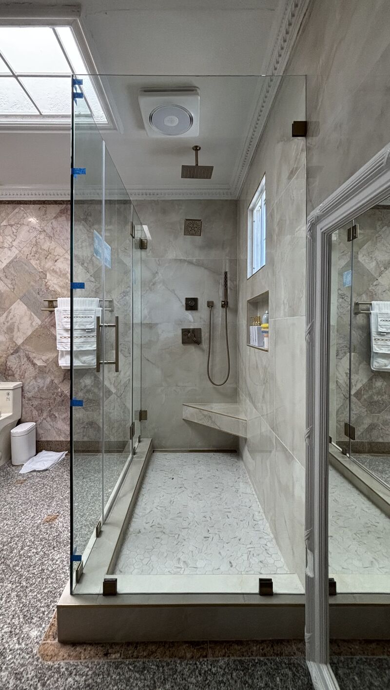 Brushed-bronze frameless multi-panel shower enclosure in Bixby Knolls, Long Beach