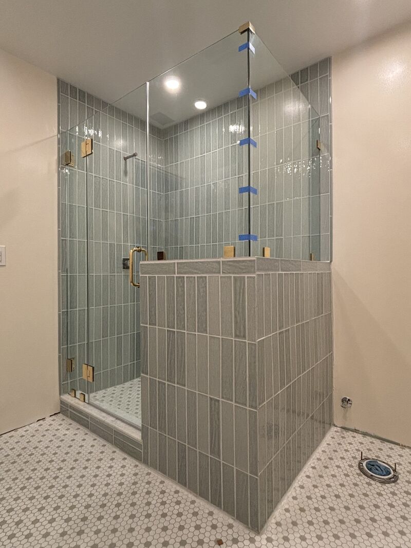 Frameless corner shower enclosure with CRL unlacquered-brass hardware in Long Beach