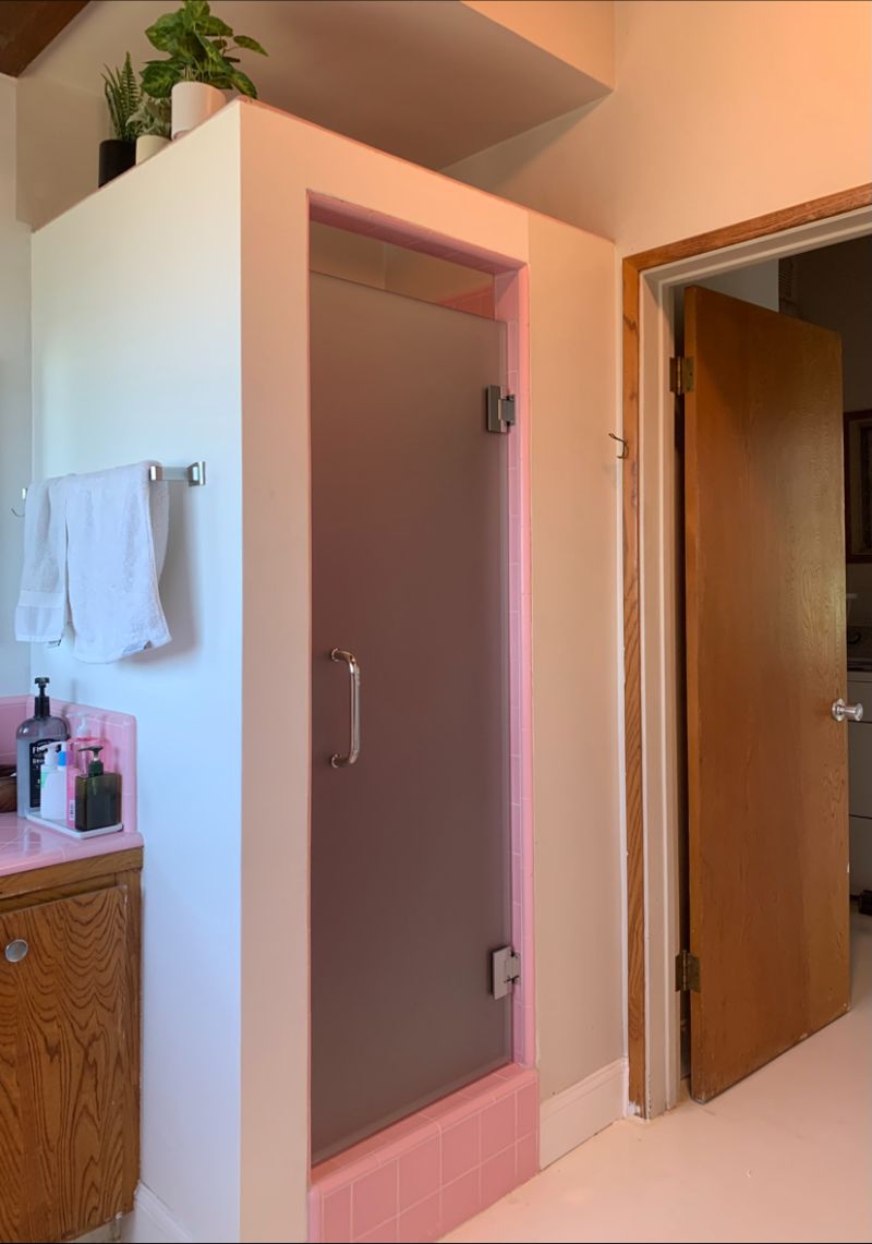 Frosted frameless shower door installed with original pink tile in Los Angeles