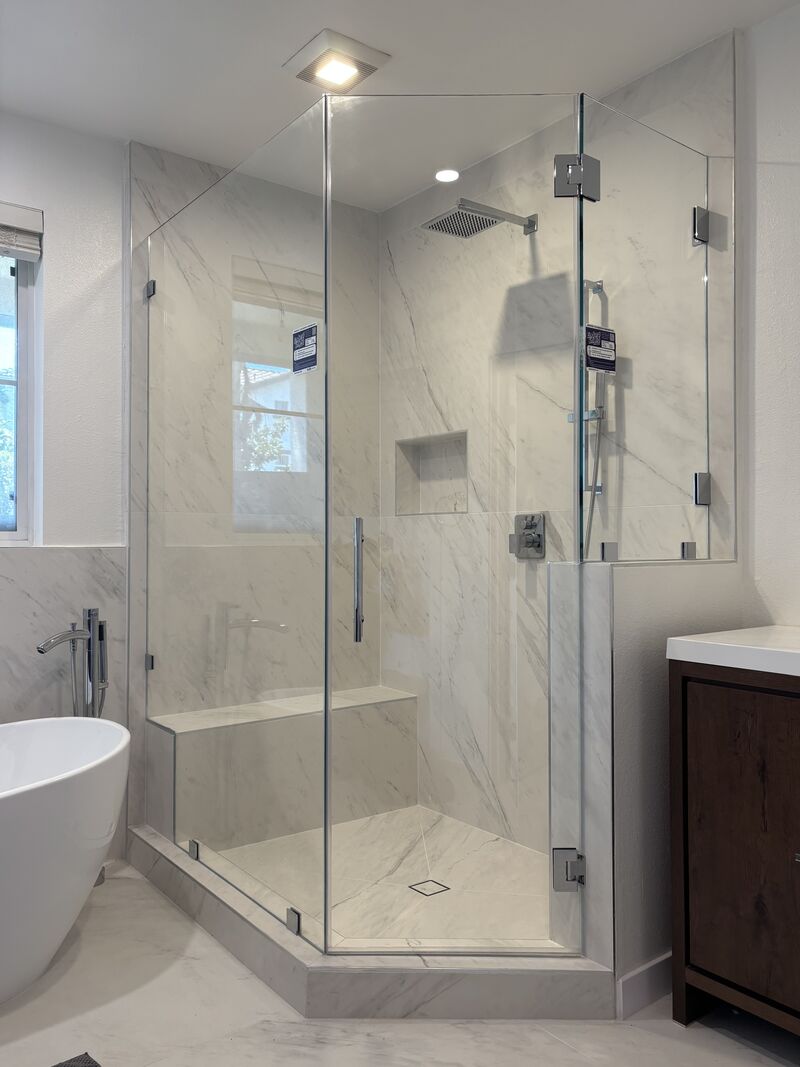 Opti-White low-iron neo-angle shower enclosure with a 175-pound bench-notched panel in Playa Vista, Los Angeles