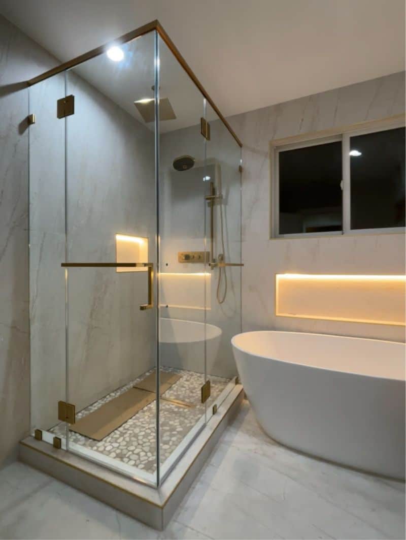 Satin-brass frameless multi-panel shower enclosure in Los Angeles