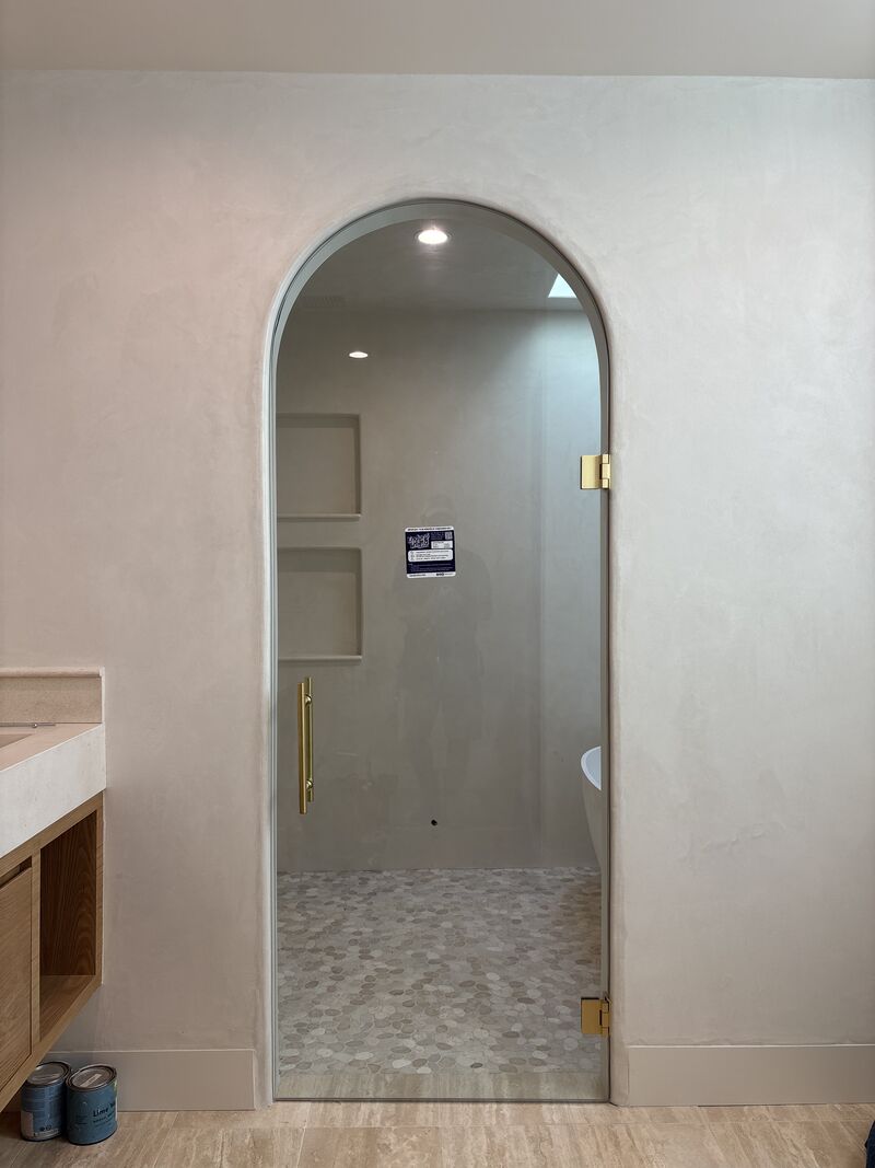 Custom frameless shower door shaped to an arched opening in Venice, Los Angeles