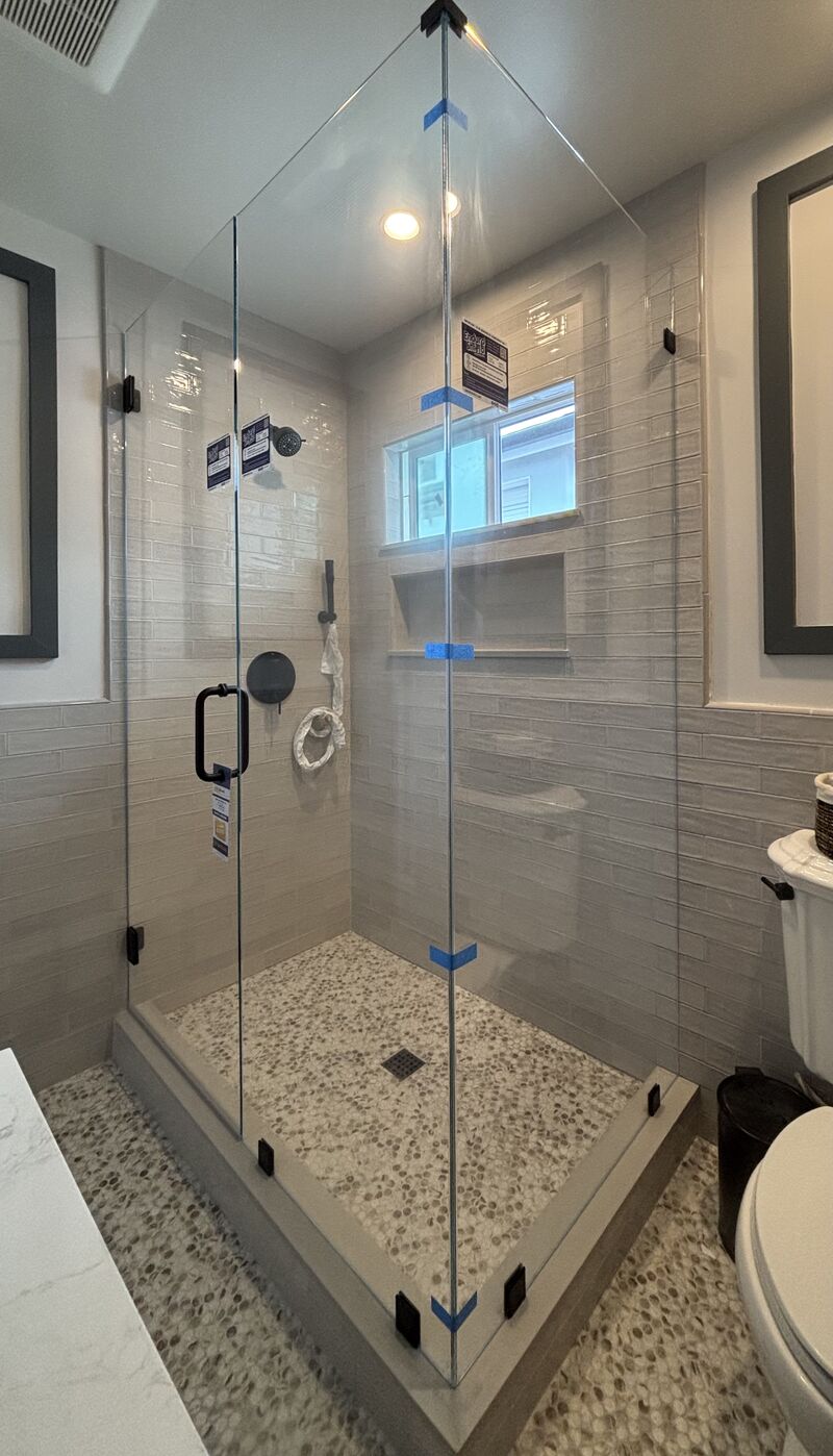 In-and-out swinging frameless corner enclosure with EnduroShield in Manhattan Beach