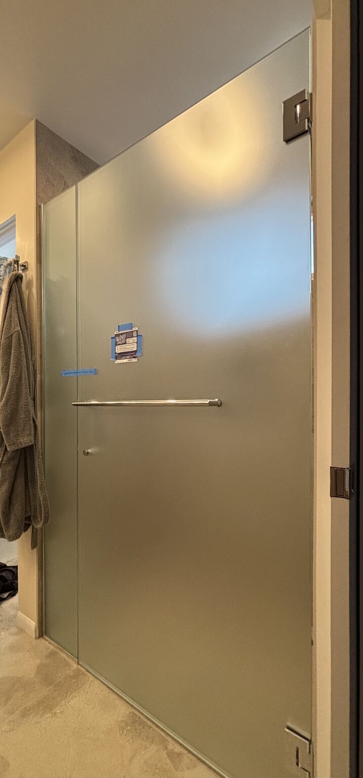 Frosted privacy-glass door and inline panel for a curbless shower in Manhattan Beach