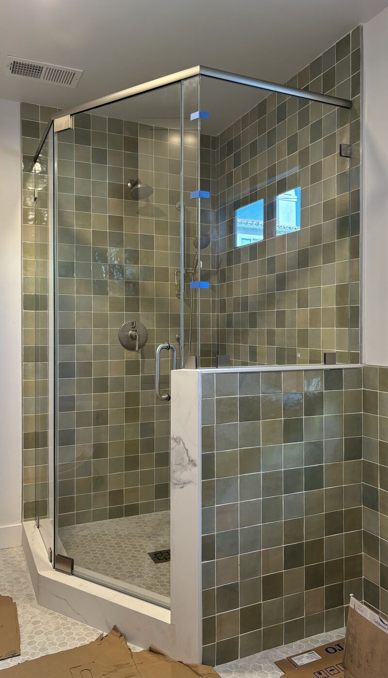 Neo-angle shower enclosure on pony wall with support header in Manhattan Beach