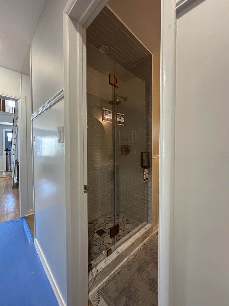 Opti-White low-iron shower enclosure with brushed-gold hardware in Manhattan Beach