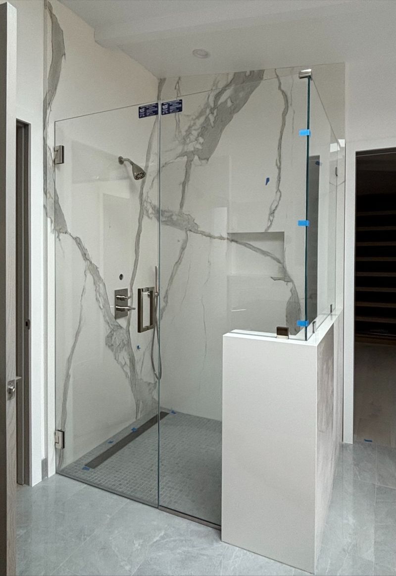 Frameless corner shower enclosure with remade door for improved fit in Manhattan Beach