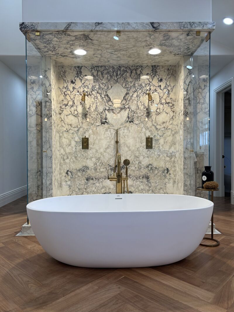 Front view of an oversized U-shaped floor-to-ceiling frameless shower enclosure installed in Newport Beach