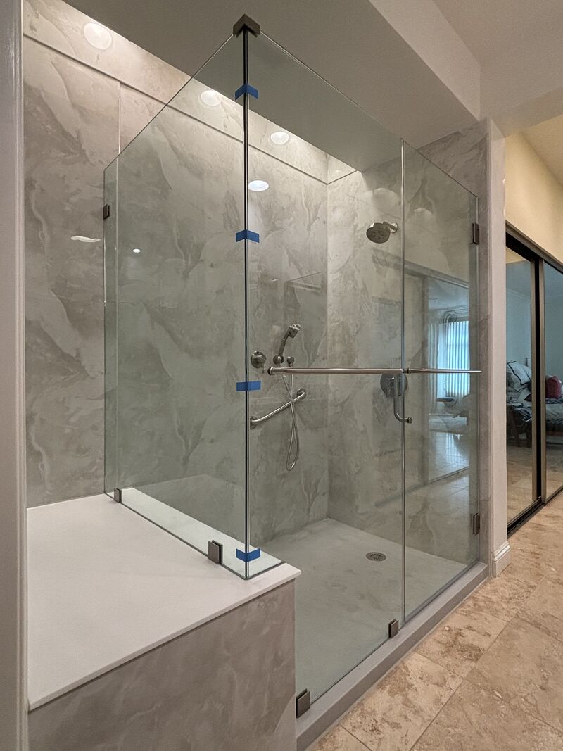 All half-inch frameless corner shower enclosure fitted to a bench in Newport Beach