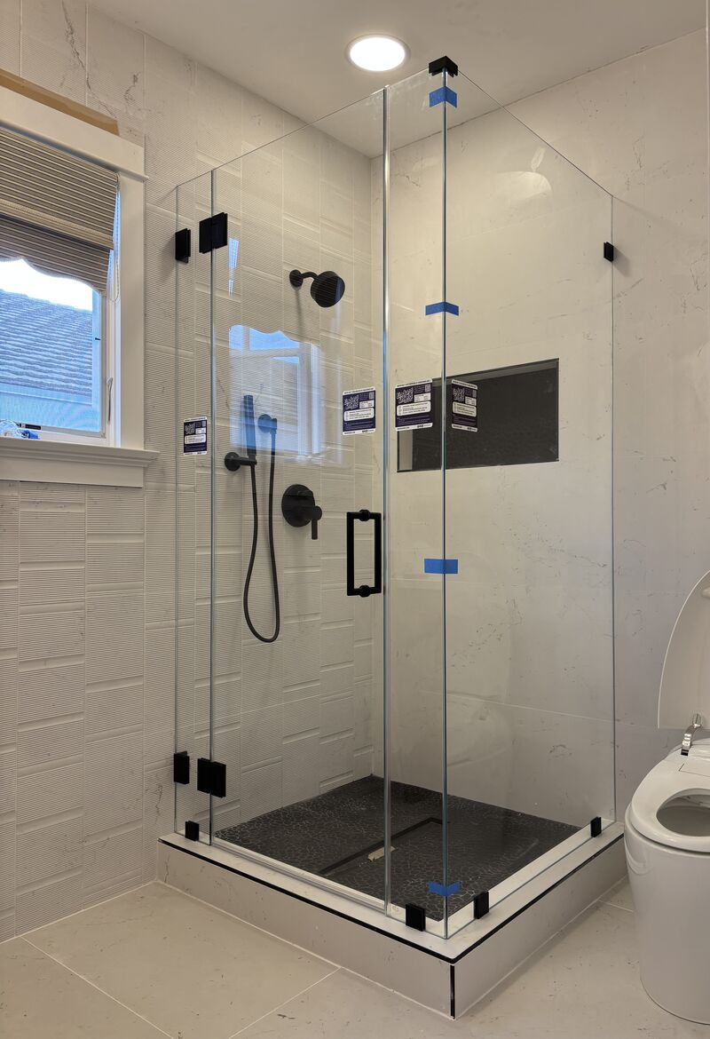 114-pound Opti-White low-iron multi-panel shower enclosure with matte-black hardware in Newport Beach