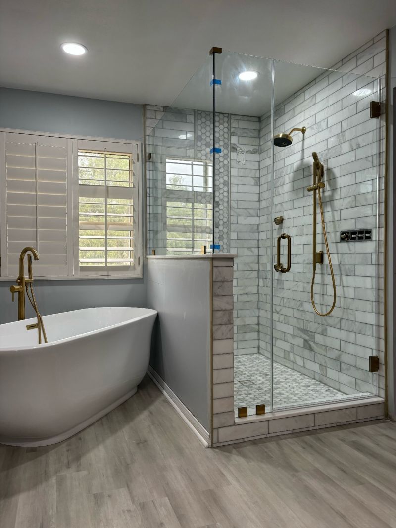 Door and corner return above a wide pony wall with brushed-gold hardware in Oceanside