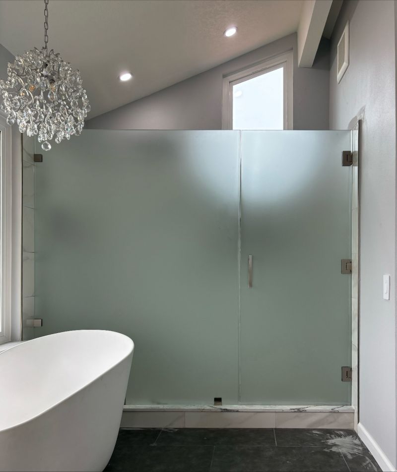 Large frosted privacy-glass shower door and inline panel installed by Affordable Frameless
