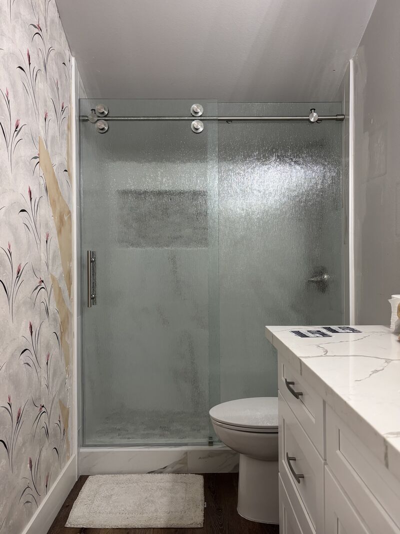Euroglide sliding shower-door system made with patterned rain glass