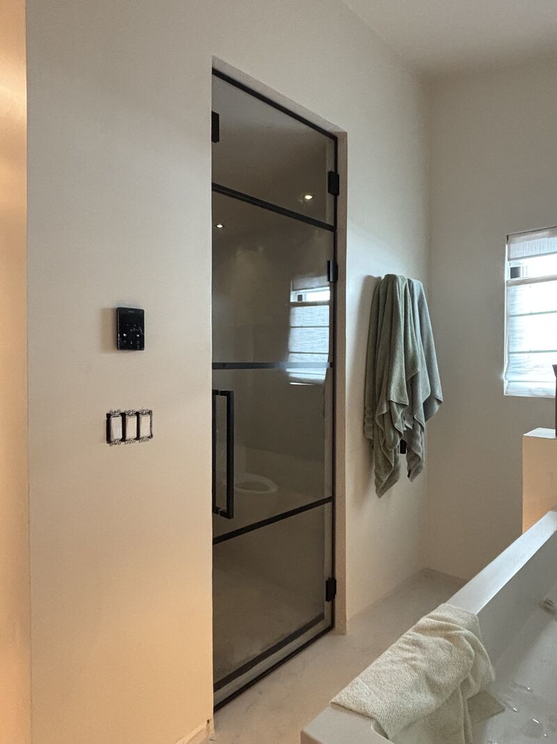 Grid-glass steam shower door with a pivoting transom in Redondo Beach