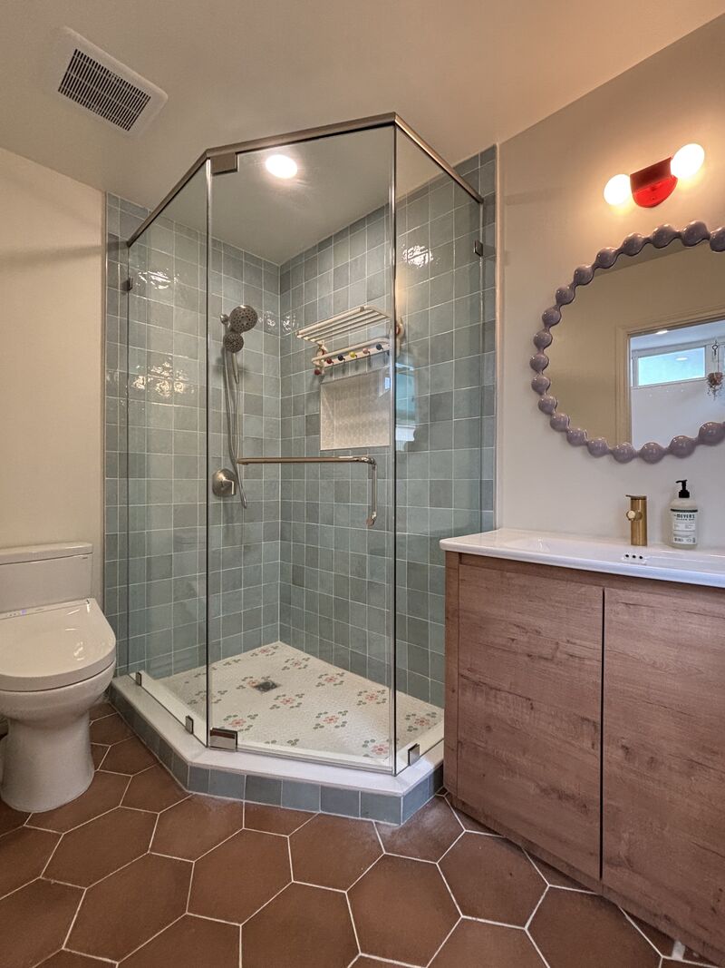Neo-angle shower enclosure with header and polished-nickel pivot hinges in Torrance